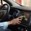 side view man driving electric car