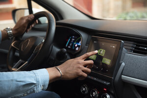 side view man driving electric car