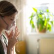 side view woman using nebulizer