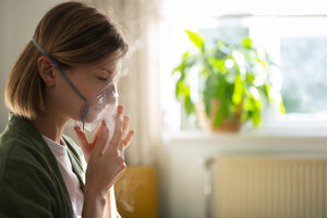 side view woman using nebulizer