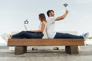 couple bench using social media