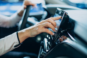 woman touching screen her car