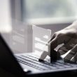 Hand using laptop computer with virtual screen and document for