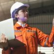 Asian female engineer specialist with Measuring machine with a manipulator armThreedimensional coordinate measurement Check sizes 3D check of the sizes of parts CMM after machining process
