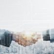 Business partners handshake global corporate with technology concept