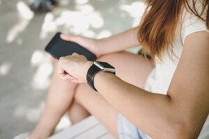 Woman using smartwatch with e-mail notifier