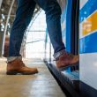 A person climbing onto a train