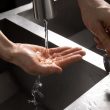 A hand under a running water tap
