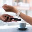 A person paying for their coffee with thier smart watch