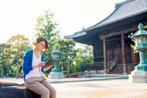 A woman in Japan reading on her tablet