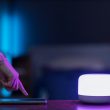 A person controlling a light through their phone