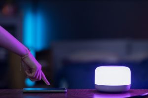 A person controlling a light through their phone