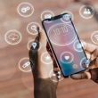 A phone with different icons floating around the phone