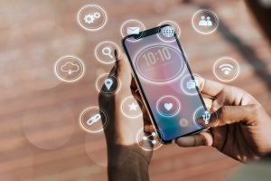 A phone with different icons floating around the phone