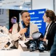 Two individuals discussing new developments at AE 2026