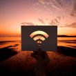 A person holding a cut out of a Wi-Fi icon