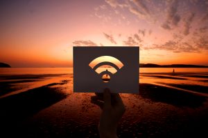 A person holding a cut out of a Wi-Fi icon