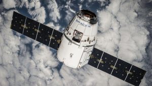 A communications satellite in orbit above Earth, representing the non-terrestrial network connectivity used in satellite IoT deployments