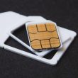 Close-up of SIM cards and eSIM chip components on a flat surface, representing eUICC hardware used in SGP.32 IoT eSIM provisioning