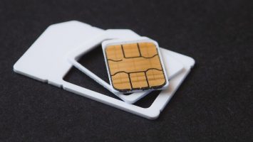 Close-up of SIM cards and eSIM chip components on a flat surface, representing eUICC hardware used in SGP.32 IoT eSIM provisioning