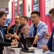 Attendees gathered around laptops at a hands-on demonstration on the exhibition floor of Barcelona Cybersecurity Congress 2025