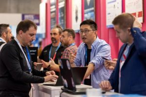 Attendees gathered around laptops at a hands-on demonstration on the exhibition floor of Barcelona Cybersecurity Congress 2025